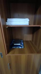 a wooden cabinet with a stack of towels in it at Luluat Al sharq Al Awsat in Makkah