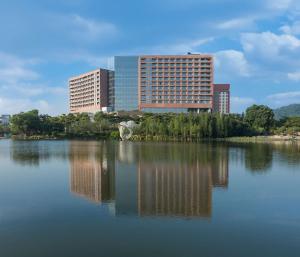 a large body of water with buildings in the background at DoubleTree by Hilton Hotel Guangzhou-Science City-Free Shuttle Bus to Canton Fair Complex and Dining Offer in Guangzhou