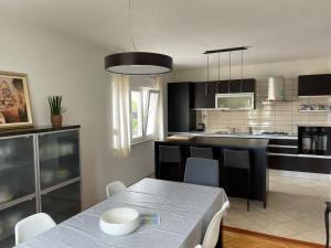 a kitchen with a table and a dining room at Apartman Maja in Vodice