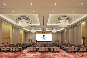 a large room with rows of chairs and a projection screen at DoubleTree by Hilton Hotel Guangzhou-Science City-Free Shuttle Bus to Canton Fair Complex and Dining Offer in Guangzhou