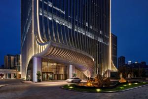a large building with a sculpture in front of it at Hilton Chongqing Liangjiang New Area in Chongqing
