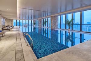 a swimming pool in the middle of a building at Hilton Chongqing Liangjiang New Area in Chongqing