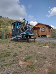 un motor de tren sentado en una mesa en un campo en HOSPEDAGEM CK, en Urubici