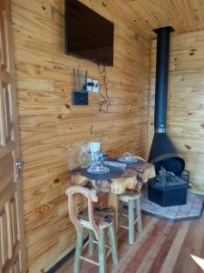a dining room with a fireplace and a table and chairs at HOSPEDAGEM CK in Urubici +13 photos