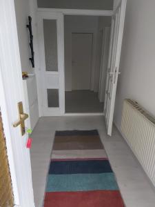a hallway with a door and a rug on the floor at Mona Apartments in Skopje