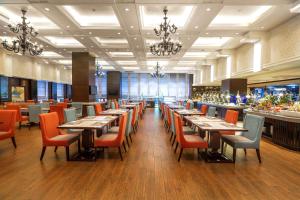 a dining room with tables and chairs and a bar at DoubleTree by Hilton Chongqing North in Chongqing