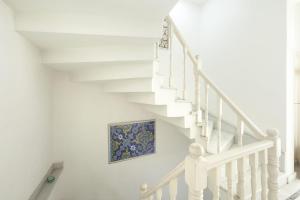 a white staircase with a painting on the wall at Pi Art Butik Otel in Istanbul