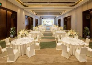 a banquet hall with white tables and white chairs at DoubleTree by Hilton Chongqing - Nan'an in Chongqing