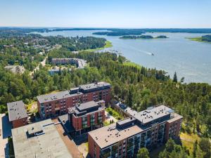 an aerial view of a building next to a body of water at Seaside Deluxe Loft - Beach, Free Parking & 10 min to Metro in Espoo