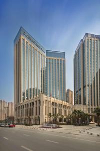 two tall buildings in a city with a street at Doubletree By Hilton Chengdu Longquanyi in Chengdu