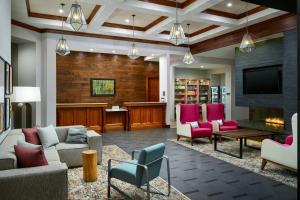 a living room with a couch and chairs and a tv at Homewood Suites Atlanta Midtown in Atlanta