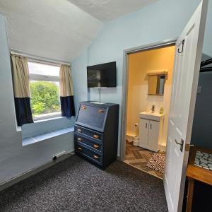Habitación pequeña con vestidor y ventana en Goonearl Simply Stay en Scorrier
