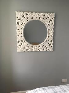 a mirror with a white frame on a wall at Logie Green - beautiful and central one bed flat in Edinburgh