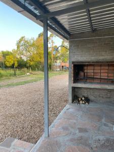 a brick fireplace with a fire inside of it at La Luisa in Termas del Daymán
