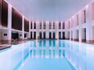 a large swimming pool in a building at Hilton Jiaxing in Jiaxing
