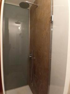 a shower with a glass door in a bathroom at A due passi dal Duomo in Cefalù
