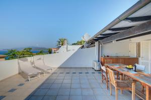 a balcony with a table and chairs on a roof at Innamorata 12 in Capoliveri