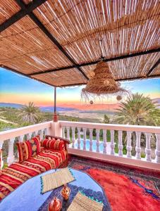 a balcony with a couch and a view of the ocean at Dar Bakkali Nadi in Tangier
