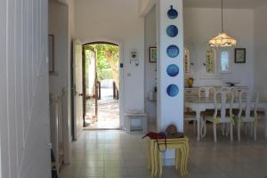 a kitchen and dining room with a table and chairs at Sea Front Villa Direct Access to Crystal Blue Sea Al Alamein, Egypt in El Alamein
