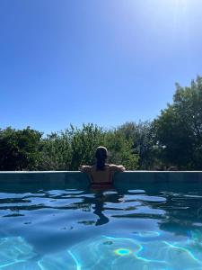 a person sitting in a swimming pool at Casa Mimosa in Candeleda