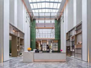 a lobby of a building with a reception desk at Doubletree By Hilton Kunming Airport in Kunming