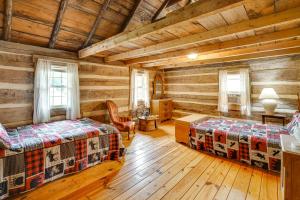 a bedroom with two beds in a log cabin at Historic Cabin Retreat about 2 Mi to Seneca Rocks! in Seneca Rocks