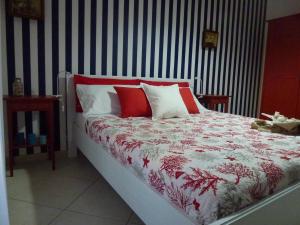 a bedroom with a bed with red and white pillows at Suite Blue Marine in Taranto