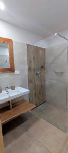 a bathroom with a shower and a sink at Chata pod Barancom in Smrečany +16 photos