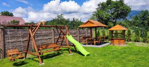 a playground with a slide and a gazebo at Chata pod Barancom in Smrečany