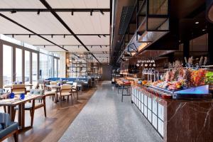 a restaurant with tables and chairs and a buffet at Hilton Guiyang in Guiyang