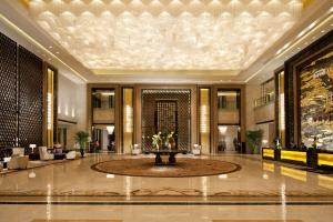 a lobby with a fountain in the middle of a building at Hilton Nanjing in Nanjing