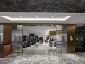 a lobby of a hotel with a marble floor at Hilton Shanghai Hongqiao in Shanghai
