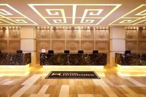a lobby with a reception desk in a building at DoubleTree by Hilton Shenyang in Shenyang