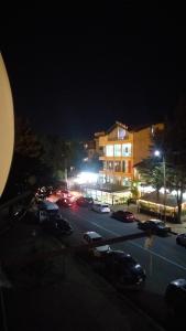 Un estacionamiento con autos estacionados frente a un edificio. en apartment in poti, en Poti 3 fotos más