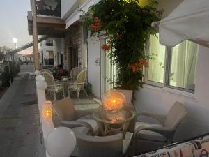 a patio with chairs and a table with candles at VILLA BLANCA in Haraki