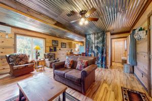 a living room with a couch and a table at Great Smoky Hideout in Gatlinburg