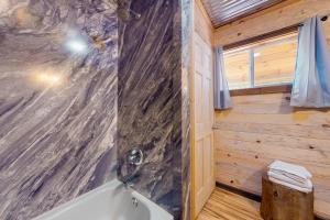 a bathroom with a shower and a bath tub at Great Smoky Hideout in Gatlinburg +26 photos