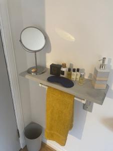 a bathroom with a shelf with a mirror and towels at Cosy loft room in Morningside, Edinburgh in Edinburgh