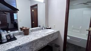 a bathroom with a sink and a toilet and a mirror at The Shelby Inn in Shelbyville