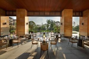 a restaurant with tables and chairs on a patio at Hilton Wuhan Optics Valley in Wuhan