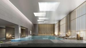 a large swimming pool in a building at Doubletree By Hilton Xian Fengdong in Xi'an