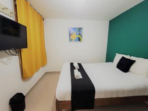 a bedroom with a bed with a black and white blanket at Hotel Dulce Luna in San Cristóbal de Las Casas