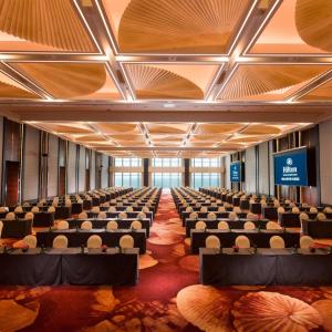 a large room with chairs and a stage in the middle at Hilton Yantai Golden Coast in Yantai +62 photos