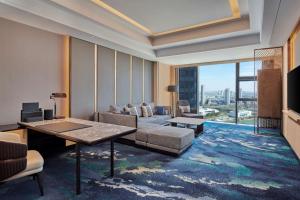 a living room with a couch and a table at Hilton Yancheng in Yancheng