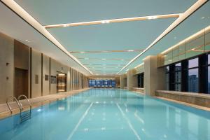 a large swimming pool in a building at Doubletree By Hilton Yangzhou in Yangzhou