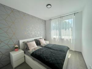 a bedroom with a bed and a window at B144 Design Lux Apartments #FreeParking in Budapest