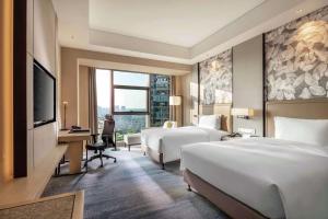 Postel nebo postele na pokoji v ubytování Doubletree By Hilton Yangzhou