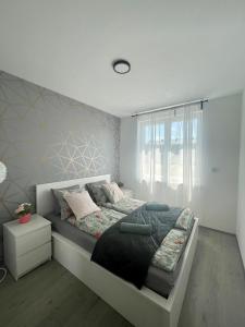 a bedroom with a bed with a large window at B144 Design Lux Apartments #FreeParking in Budapest