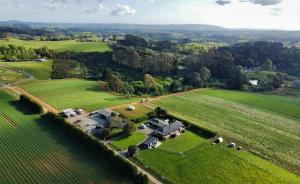 an aerial view of a house in the middle of a field at Heaven's Rest B&B in Pukekohe East