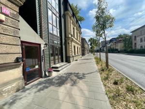 an empty sidewalk next to a building on a street at Modern guest house in city center I Room 3 in Vilnius